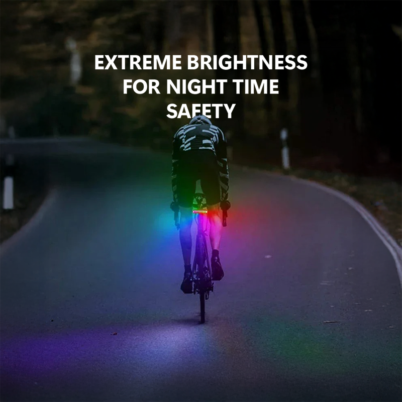 Cyclist riding at night with Cyclight illuminating the road in RGB colors